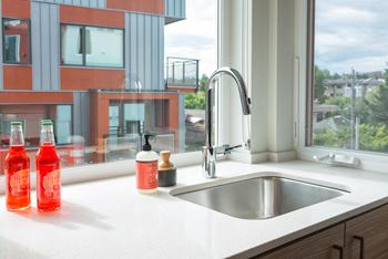 A kitchen sink in front of a window
